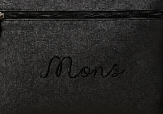 Close-up of the black back: MONS logo and zip